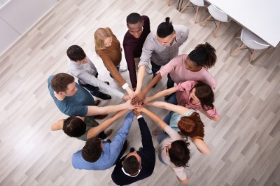 Team with hands gathered together