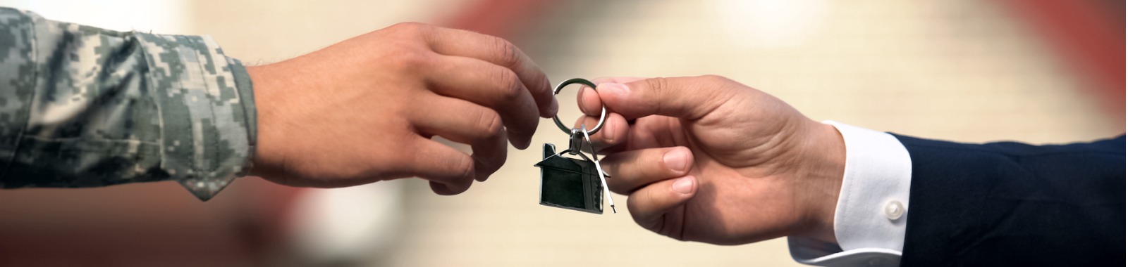 business man giving military man house key