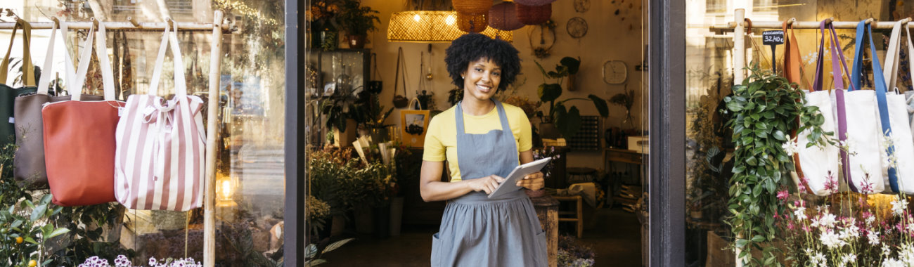 woman standing outside her store
