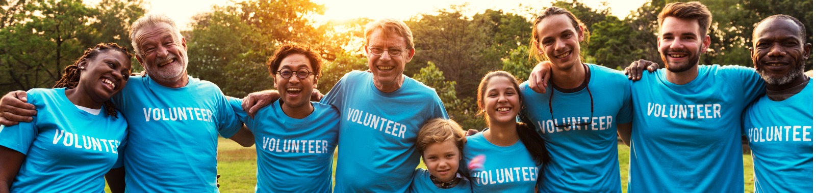 Group of people gathered together and smiling for volunteer work